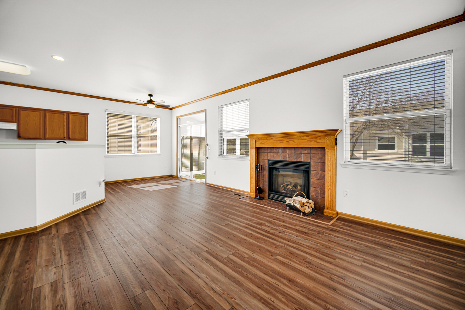 690 Wellston Lane Romeoville, IL 60446 - Photo 8 of 22 a view of a livingroom with wooden floor and a fireplace