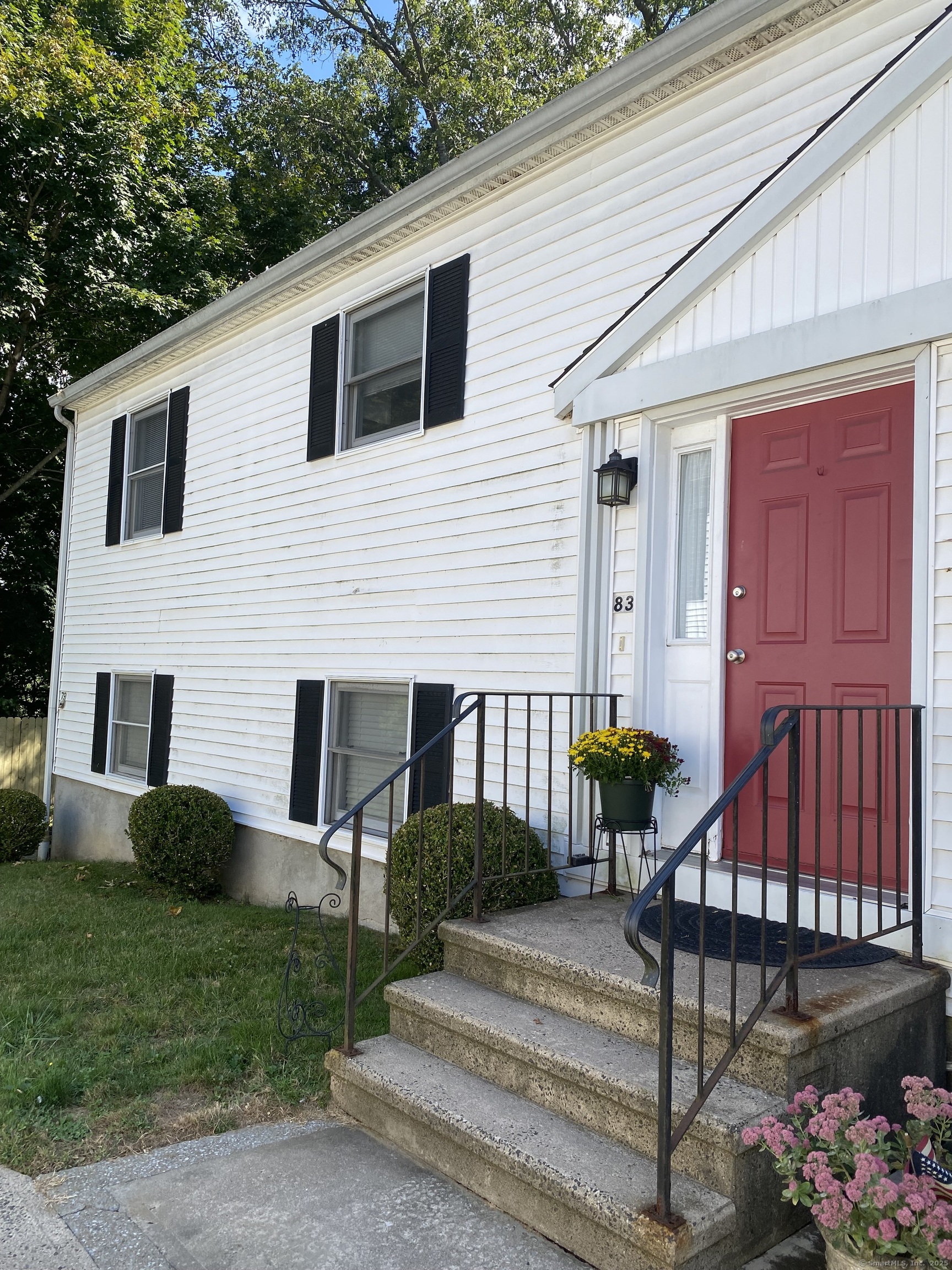 a front view of a house with entryway and garden