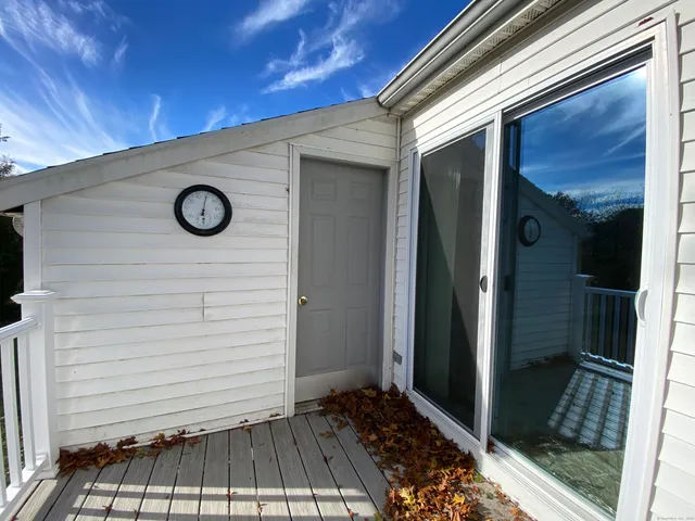 a view of balcony with wooden floor and fence