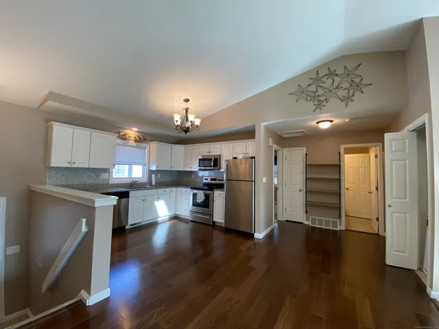 a view of a kitchen with a sink and a refrigerator