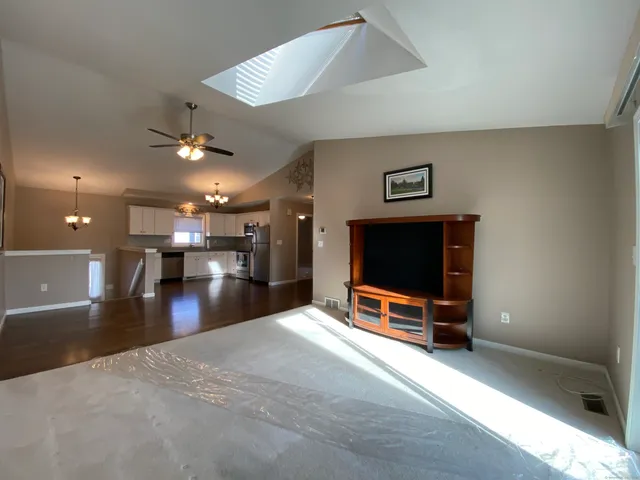 a view of a livingroom with furniture and a flat screen tv