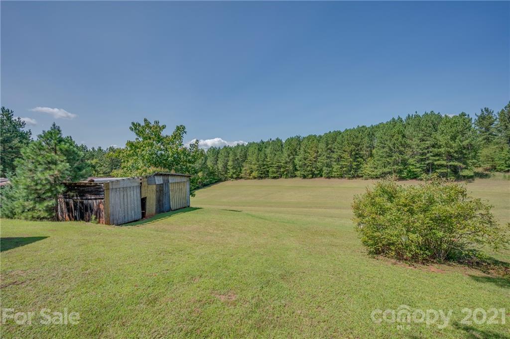 2330 Polk County Line Road Rutherfordton, NC 28139 - Photo 18 of 47 a view of a lake with a house in the background