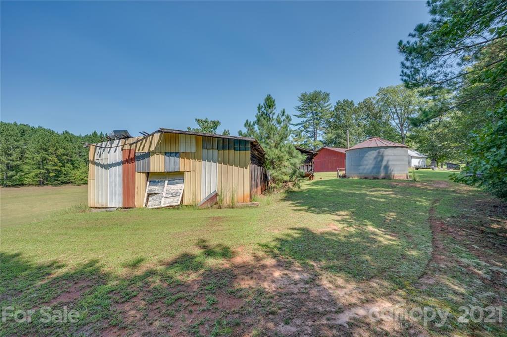 2330 Polk County Line Road Rutherfordton, NC 28139 - Photo 29 of 47 a blue swimming pool is in front of a big yard with large trees