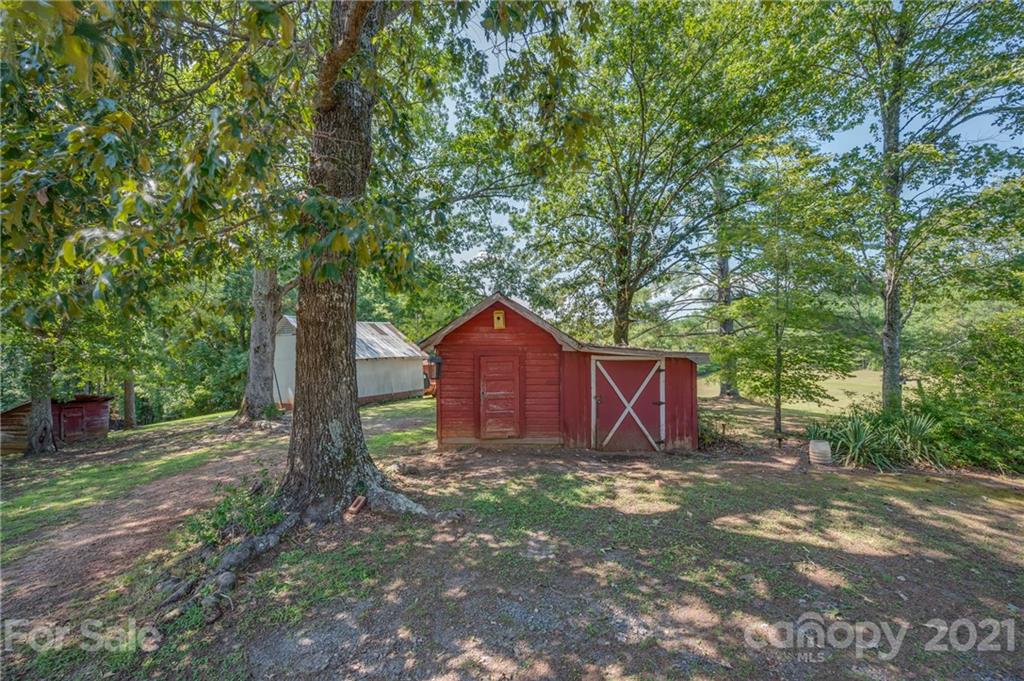 2330 Polk County Line Road Rutherfordton, NC 28139 - Photo 30 of 47 a view of backyard with large trees and wooden fence