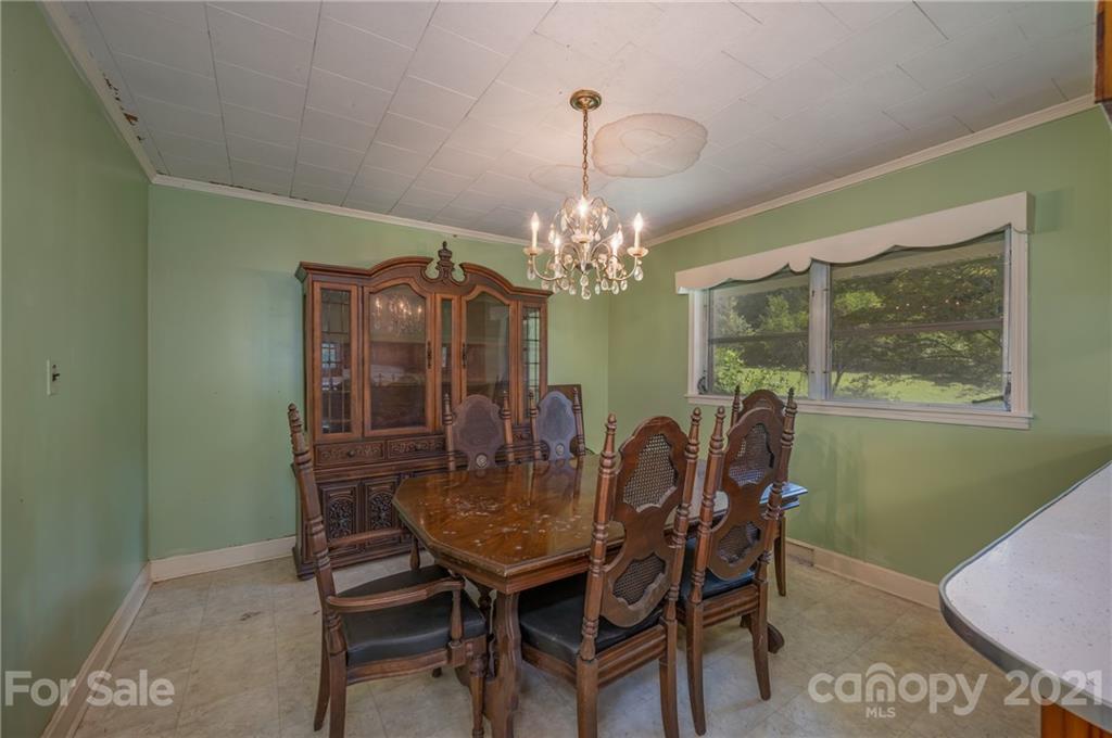 2330 Polk County Line Road Rutherfordton, NC 28139 - Photo 38 of 47 a view of a dining room with furniture and a chandelier