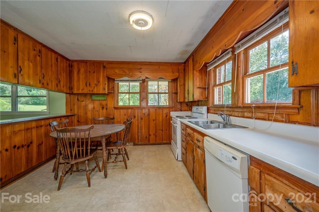 2330 Polk County Line Road Rutherfordton, NC 28139 - Photo 40 of 47 a kitchen with a table chairs sink and cabinets