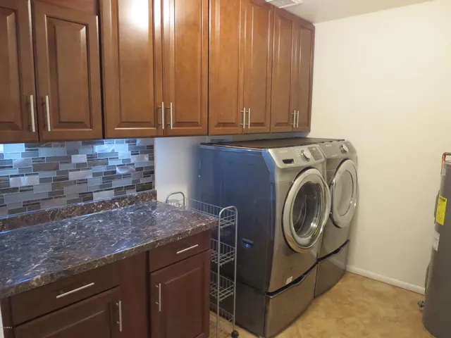a kitchen with a sink a washer and dryer