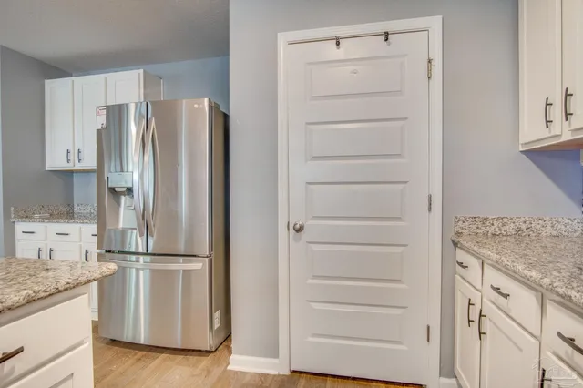 a kitchen with appliances cabinets and a counter top space
