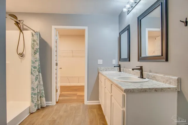 a bathroom with a sink a mirror and a shower