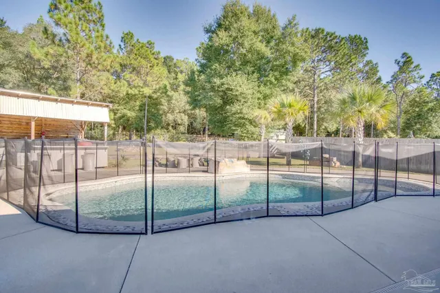 a view of a patio with table and chairs potted plants with wooden floor and fence