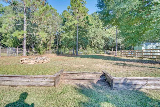 a view of a house with a big yard and swimming pool