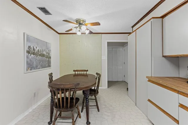 a dining room with a table and chairs