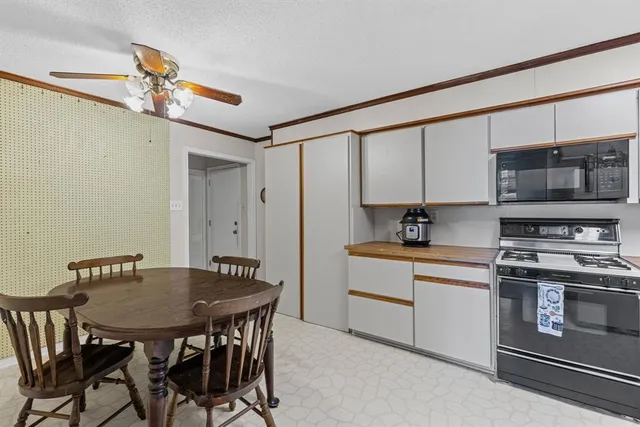 a kitchen with stainless steel appliances a stove a sink and a refrigerator