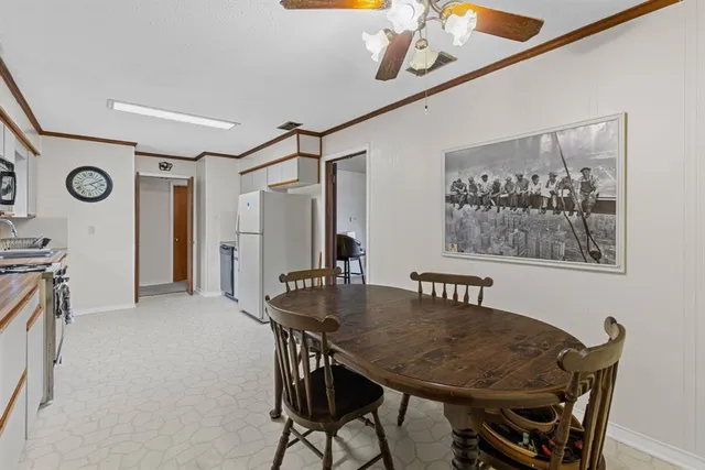 a view of a dining room with furniture and a chandelier
