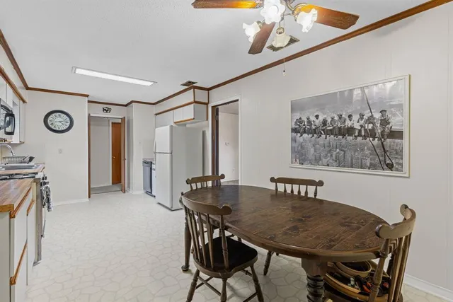 a view of a dining room with furniture and window