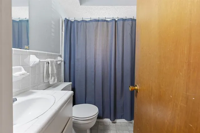 a white toilet sitting next to a bathroom sink