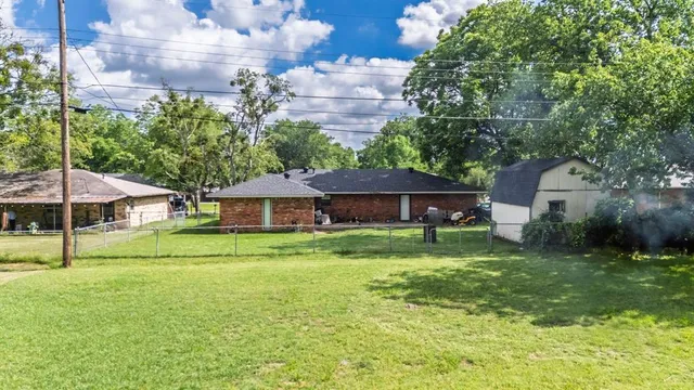 a view of a garden with large trees