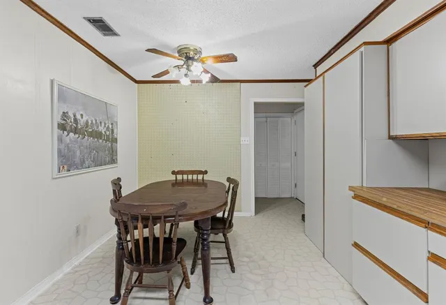 a dining room with a wooden table and chairs