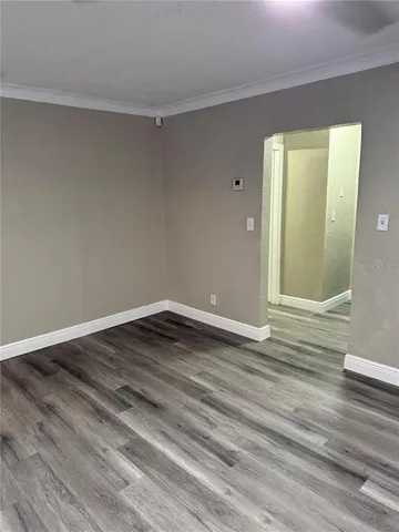 a view of a room with wooden floor