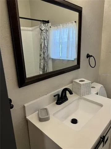 a bathroom with a sink and a mirror