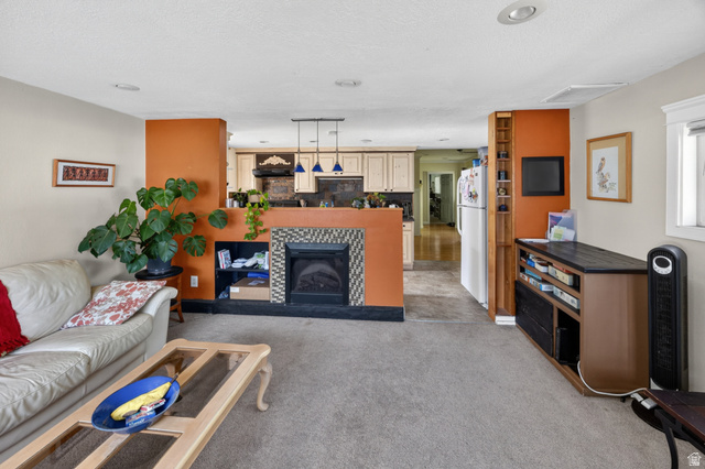 730 East 200 North Logan, UT 84321 - Photo 6 of 28 Living area featuring a built-in fireplace with a tiled surround, recessed lighting, and a built-in shelving unit