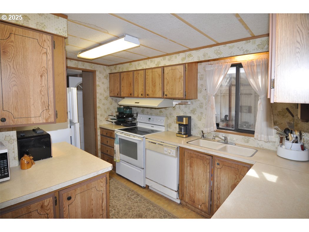 18385 South Springwater Road Estacada, OR 97023 - Photo 15 of 22 a kitchen with a sink appliances cabinets and a counter top space
