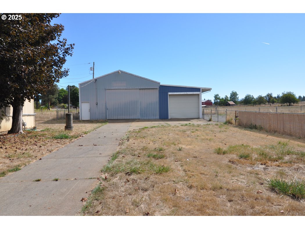 18385 South Springwater Road Estacada, OR 97023 - Photo 2 of 22 a view of a dirt road and a building in the background