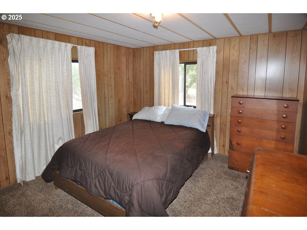 18385 South Springwater Road Estacada, OR 97023 - Photo 21 of 22 a bedroom with a bed and a dresser