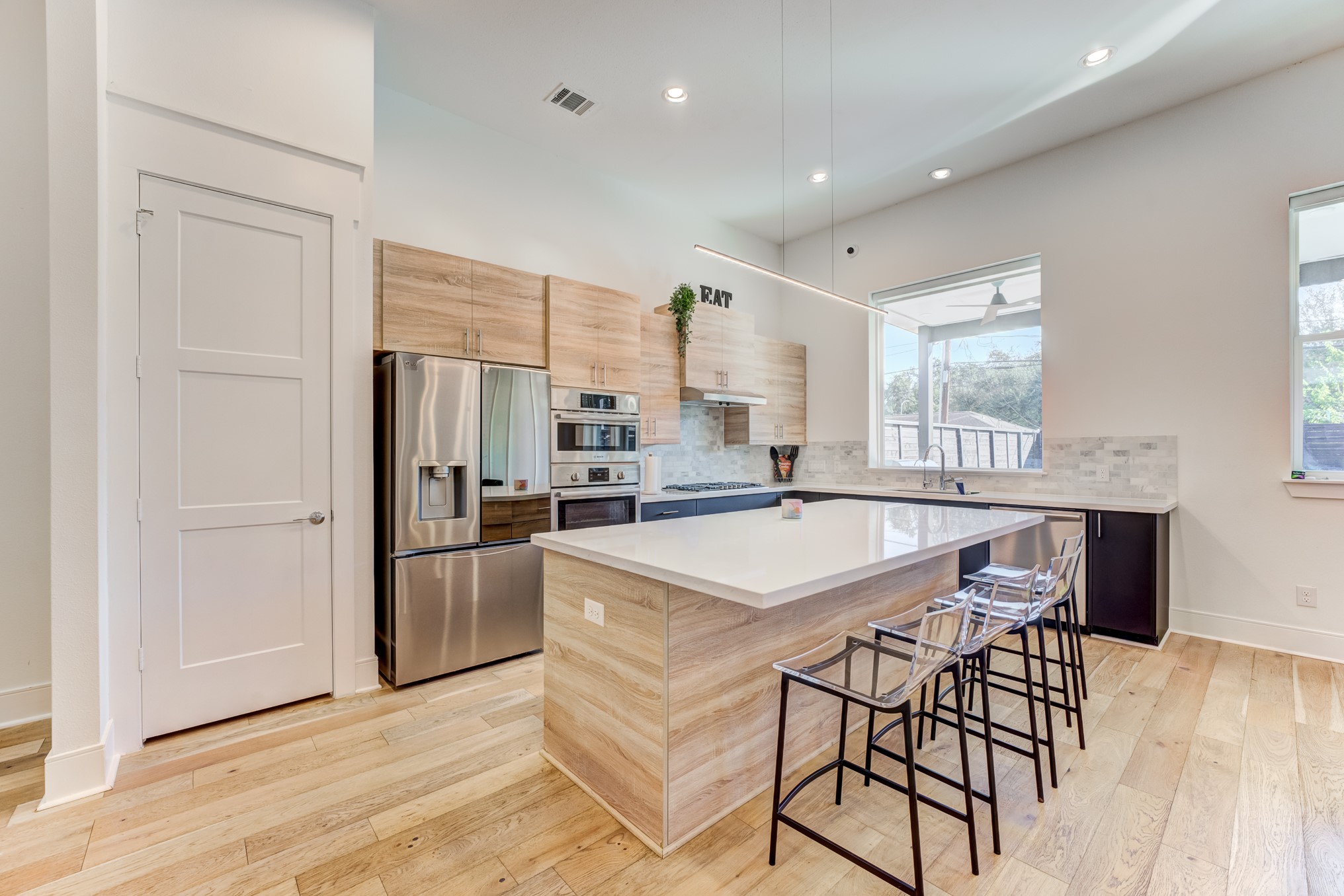 3406 Asher Landing Lane Houston, TX 77080 - Photo 13 of 45 a kitchen with stainless steel appliances granite countertop a kitchen island hardwood floor sink stove and granite counter top