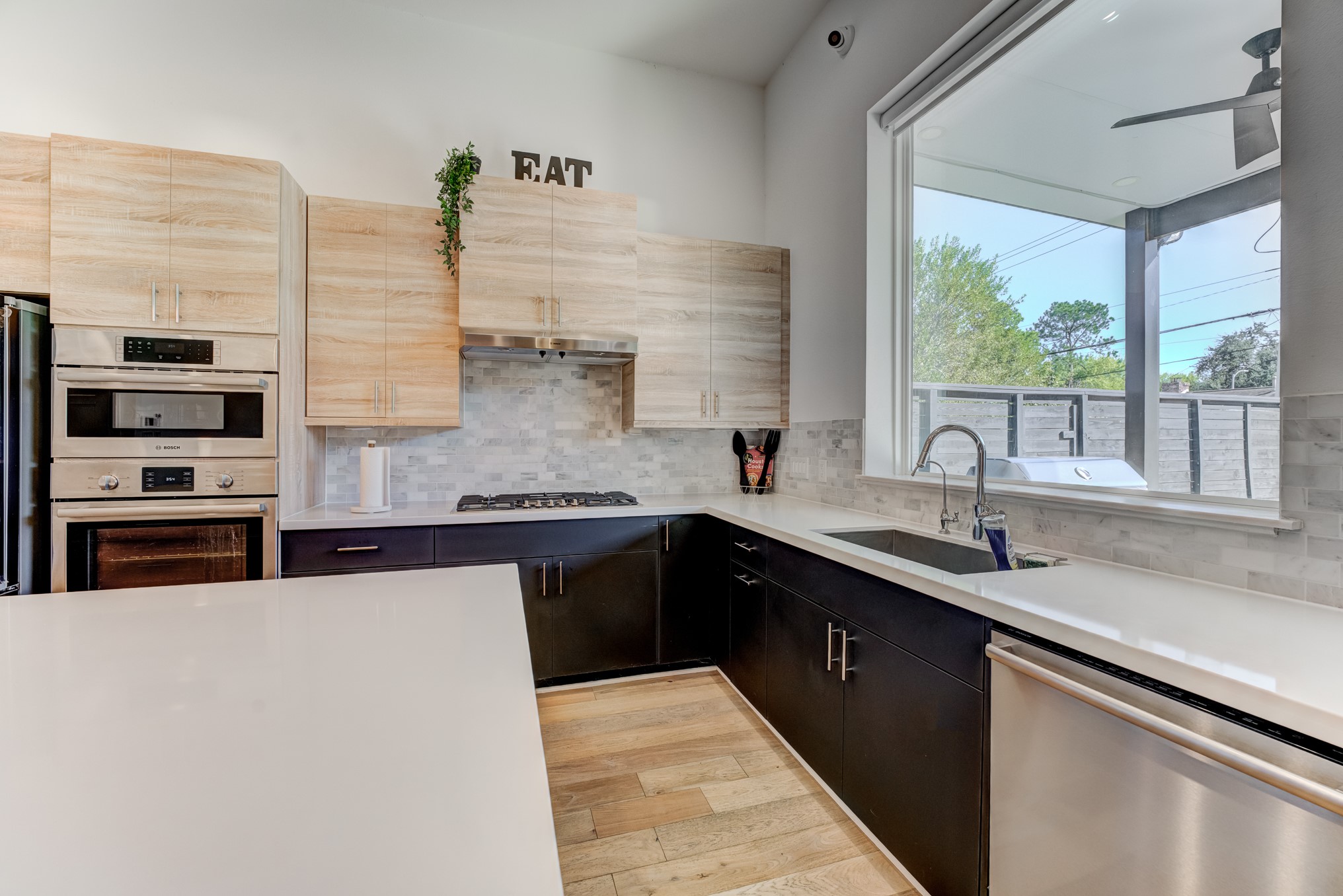 3406 Asher Landing Lane Houston, TX 77080 - Photo 14 of 45 a kitchen with stainless steel appliances granite countertop a sink and wooden cabinets