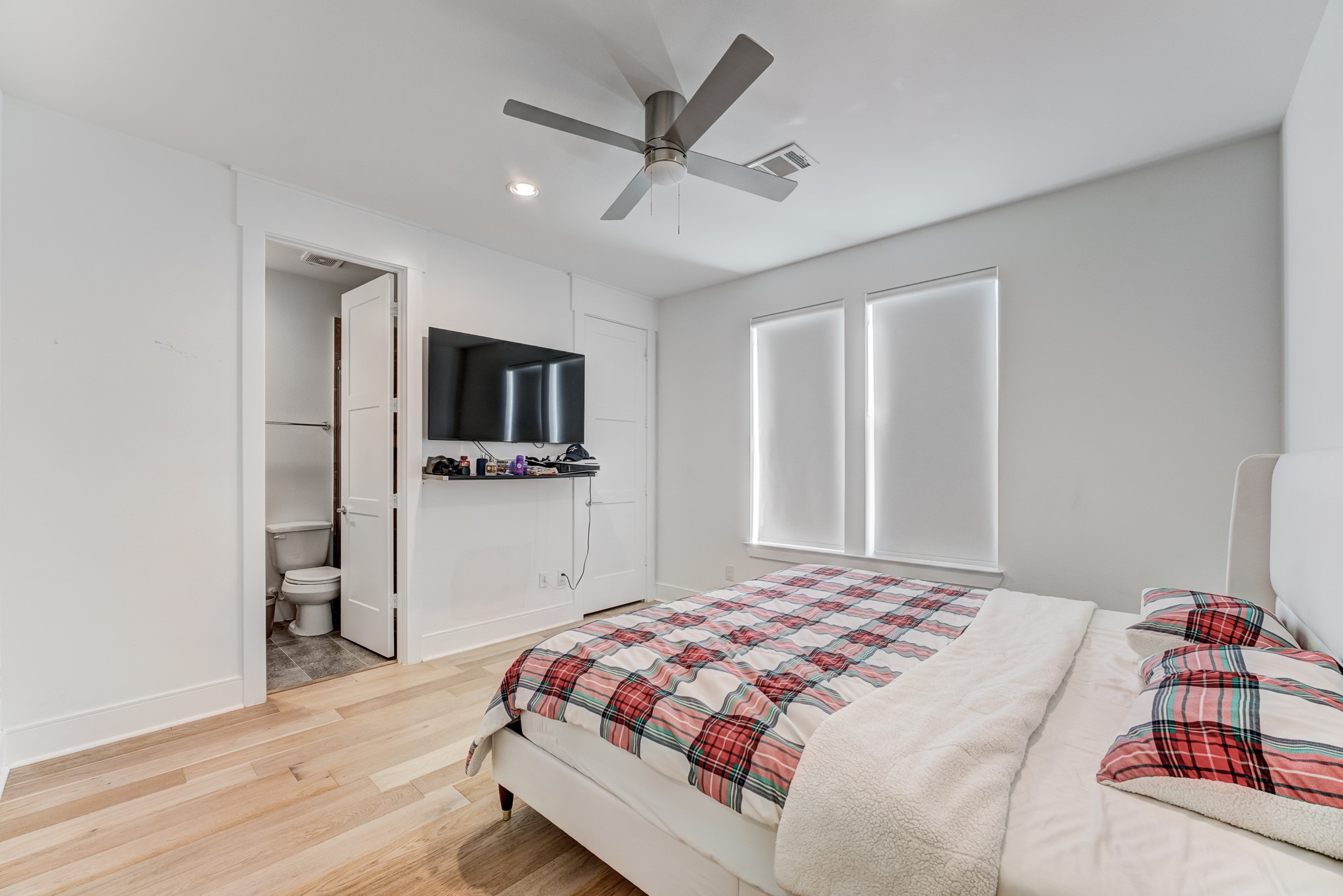 3406 Asher Landing Lane Houston, TX 77080 - Photo 26 of 45 a bedroom with a bed and a flat tv screen on dresser