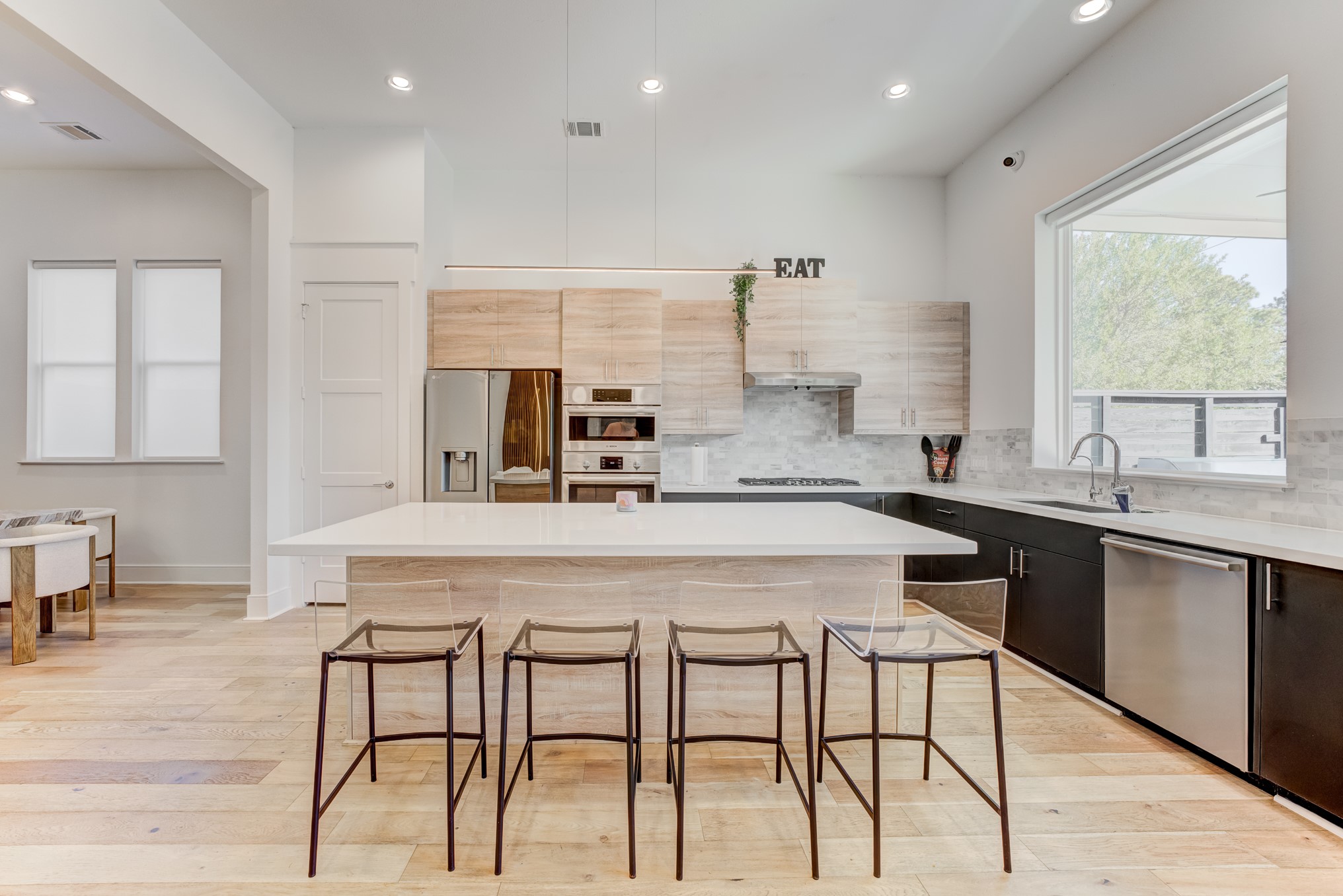 3406 Asher Landing Lane Houston, TX 77080 - Photo 9 of 45 a kitchen with a table chairs sink and cabinets