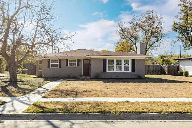 a front view of a house with a yard covered in snow