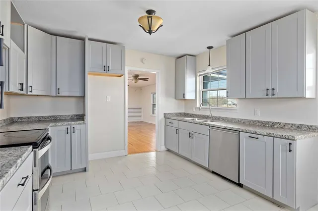 a kitchen with granite countertop cabinets and stainless steel appliances