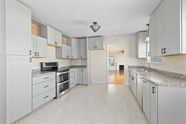 a large kitchen with cabinets and stainless steel appliances