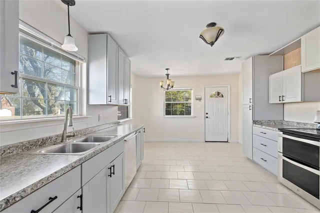 a kitchen with a sink stove and cabinets