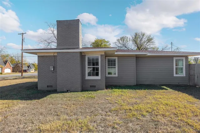 a view of a house with a small yard and a large window