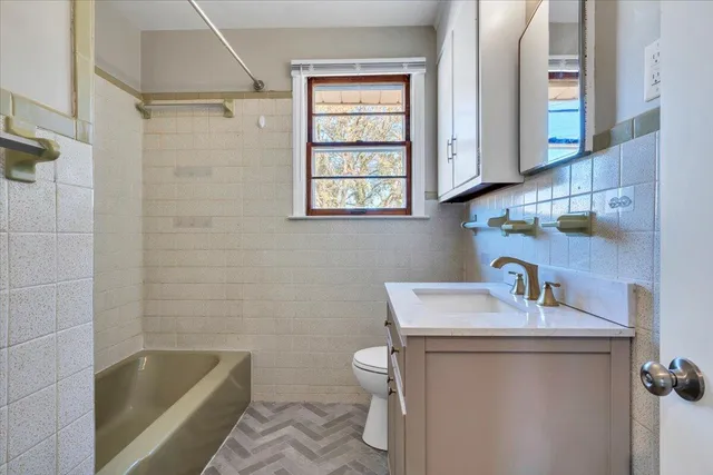 a bathroom with a sink a toilet and bathtub