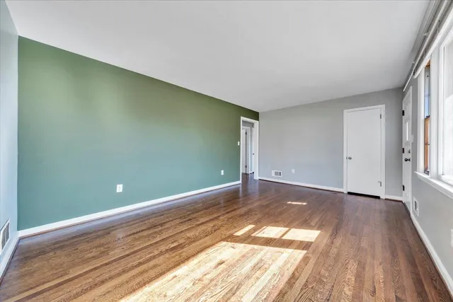 a view of a room with wooden floor and bathroom
