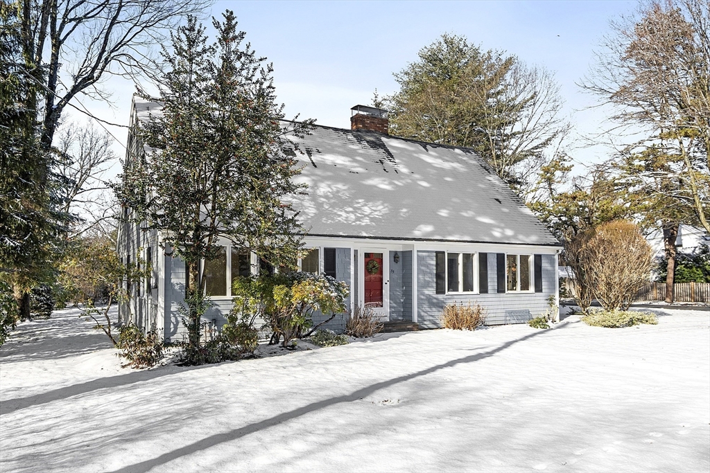 a front view of house with yard and trees around