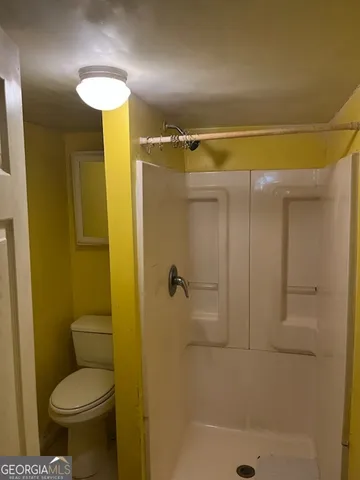 a bathroom with a shower and a toilet