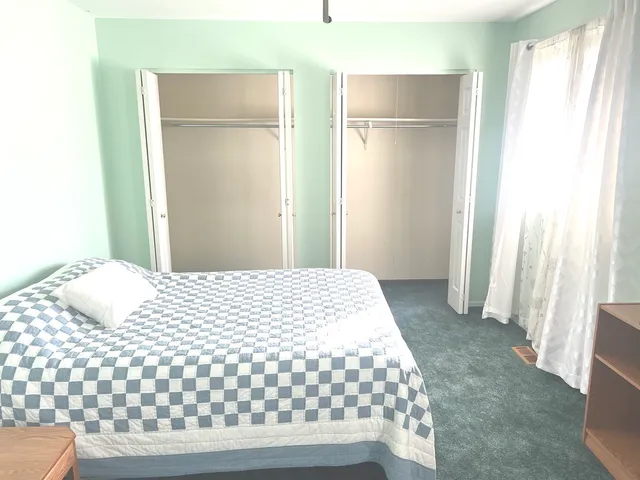 a bedroom with a bed and a window