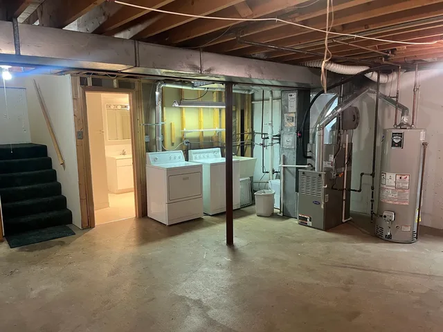 a view of an empty room with wooden floor and windows