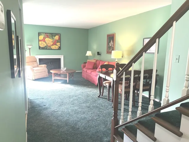 a living room with furniture and stairs