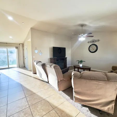 a kitchen with stainless steel appliances granite countertop a kitchen island a stove a sink a microwave and a refrigerator