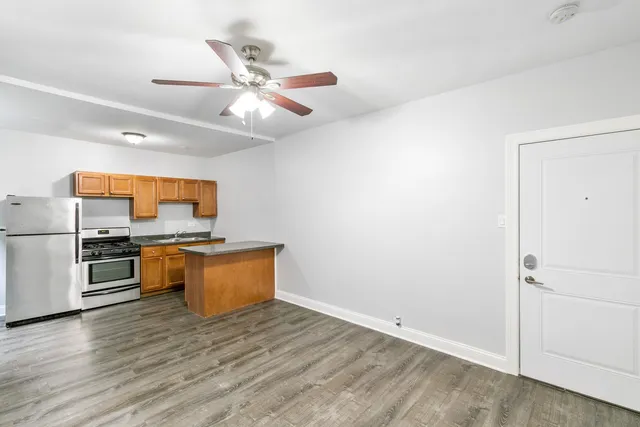 a kitchen with stainless steel appliances a white stove top oven and a refrigerator