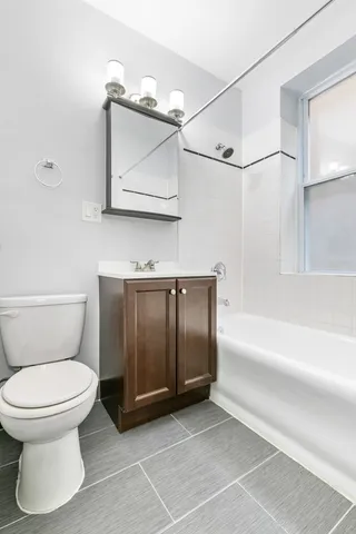 a bathroom with a toilet a sink and bathtub