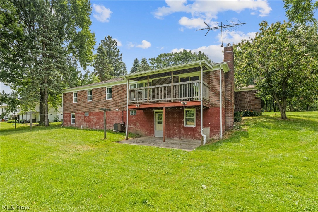 16295 Sperry Road Vermilion, OH 44089 - Photo 41 of 48 Back of property with a patio, a yard, and central air condition unit