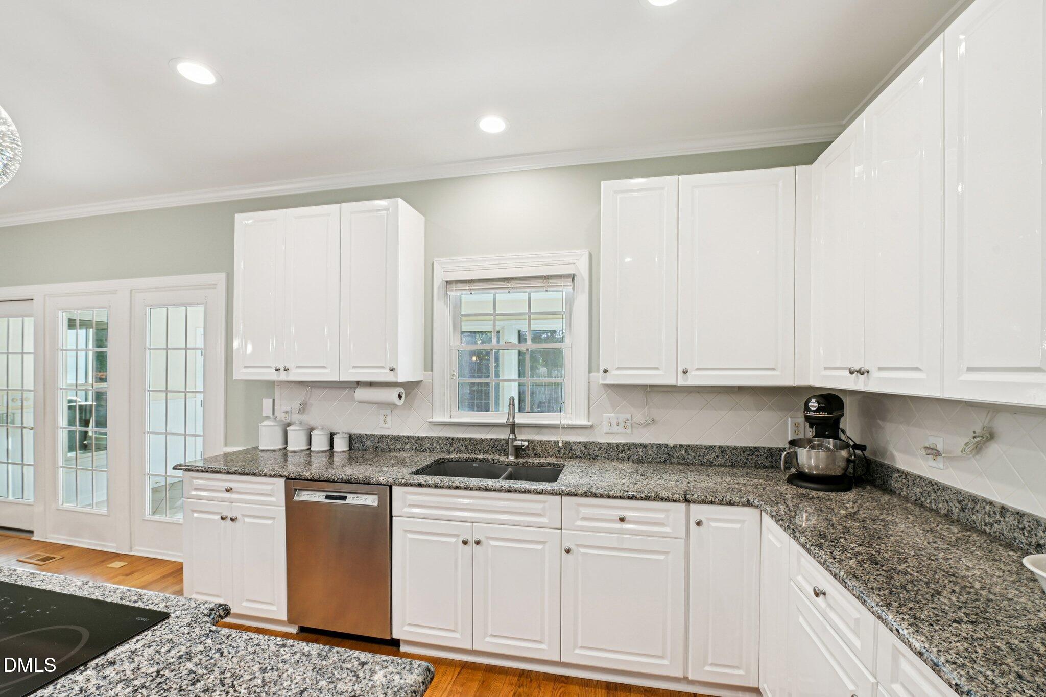200 Ridge Creek Drive Morrisville, NC 27560 - Photo 11 of 38 a kitchen with granite countertop white cabinets and a granite counter tops