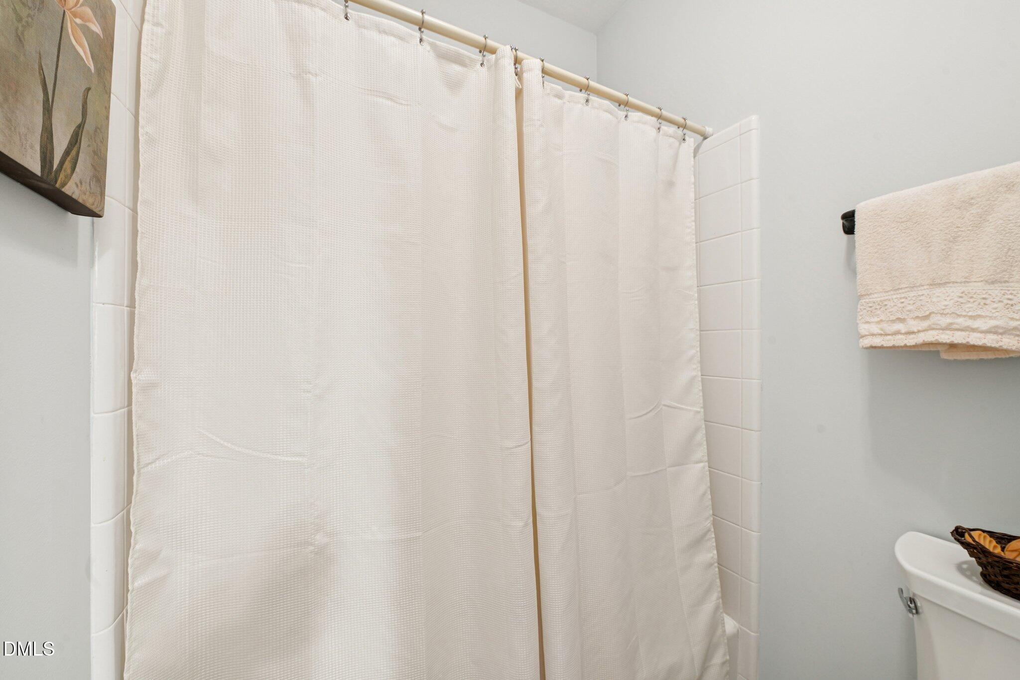 200 Ridge Creek Drive Morrisville, NC 27560 - Photo 19 of 38 a bathroom with a shower curtain and a sink